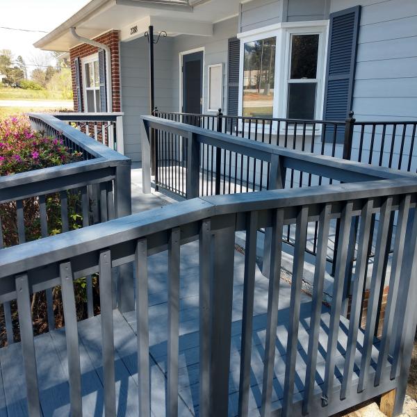 Newly finished blue deck walkway with railing.