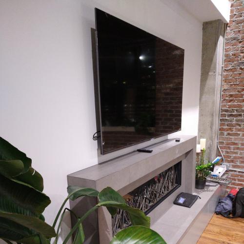 Large flatscreen tv installed over mantle.